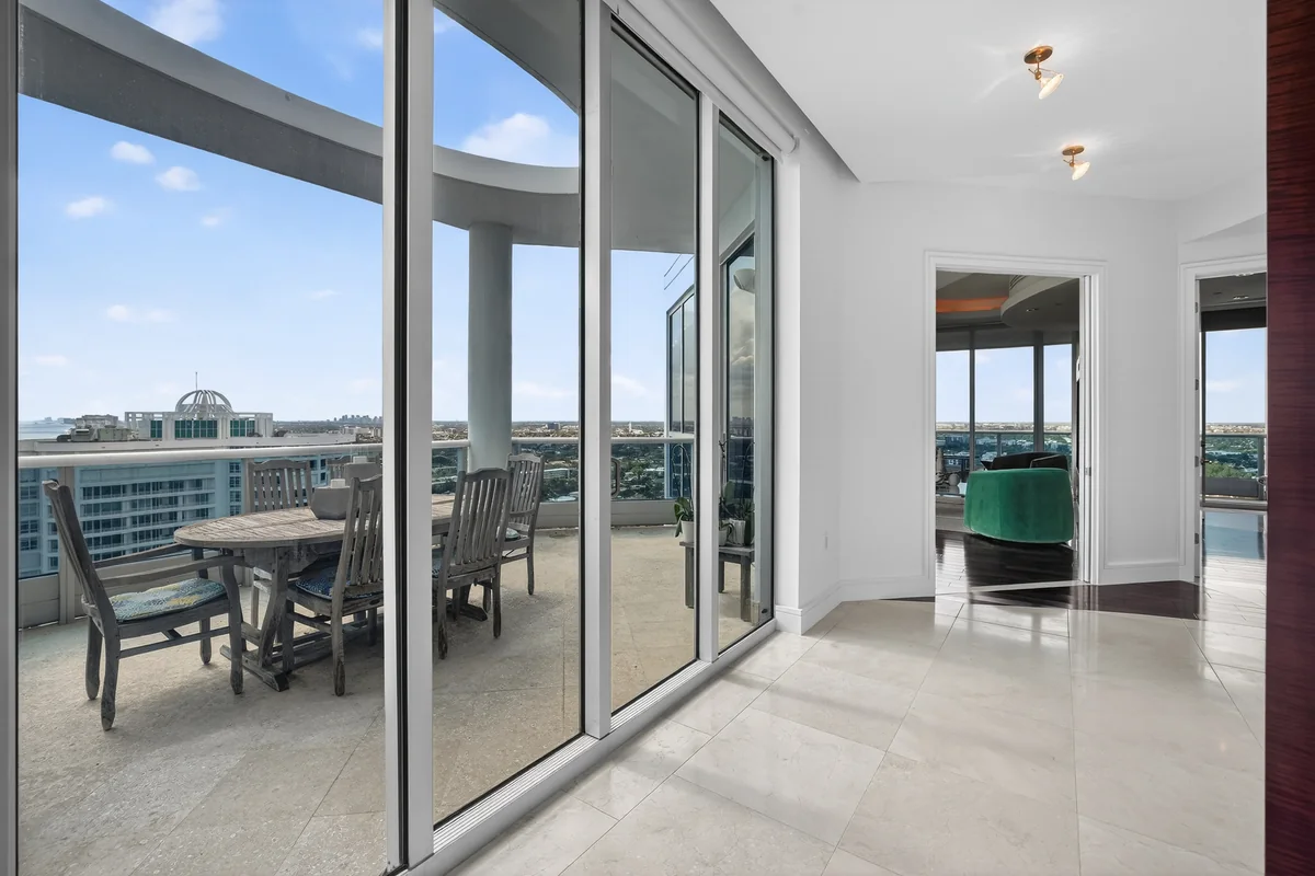 Curved wall of glass and the Atlantic from inside the upper penthouse
